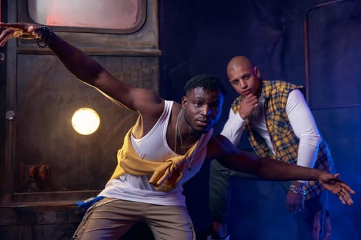 Two modern hip-hop dancers in garage performing urban freestyle dance. Battle competition and youth culture