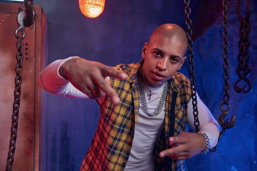 Young stylish hip hop musician hanging out in atmospheric garage studio. Ghetto music enjoyment