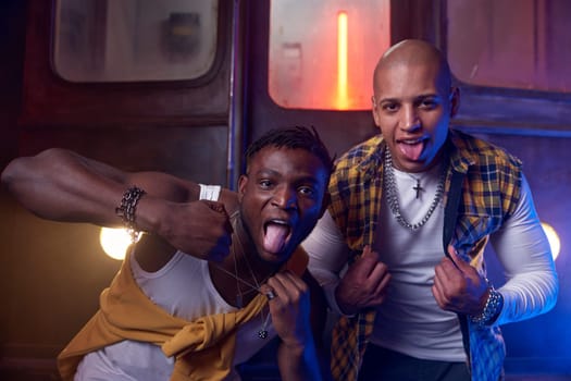 Two emotional guys performing hip-hop style in underground. Young people crazy about rap