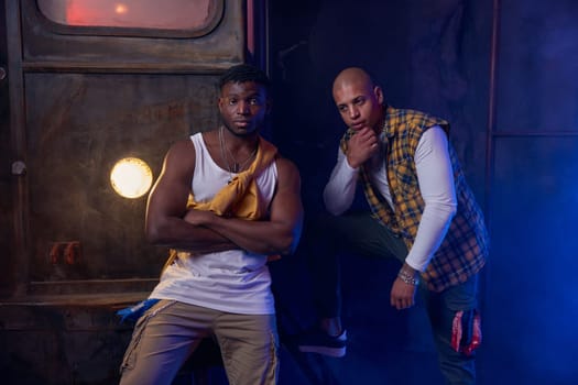 Two modern hip-hop dancers in garage performing urban freestyle dance. Battle competition and youth culture