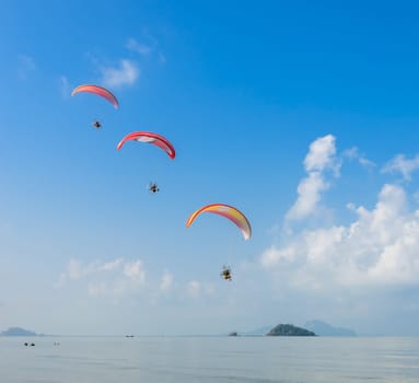 Three Paragliding over Pak Meng Beach in Trang province, Thailand