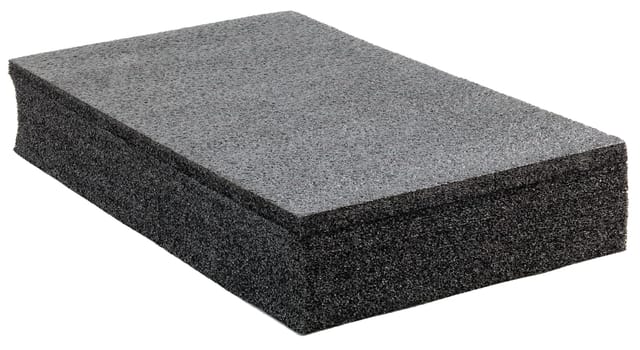 Black high-impact closed-cell polyethylene black foam brick isolated on white background. Specifically designed packing material.