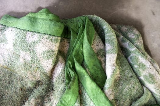 Detail of dirty blanket thrown in the trash, recycling