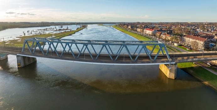 aerial shot of the Deventer railroad bridge over the ijssel river in the Netherlands