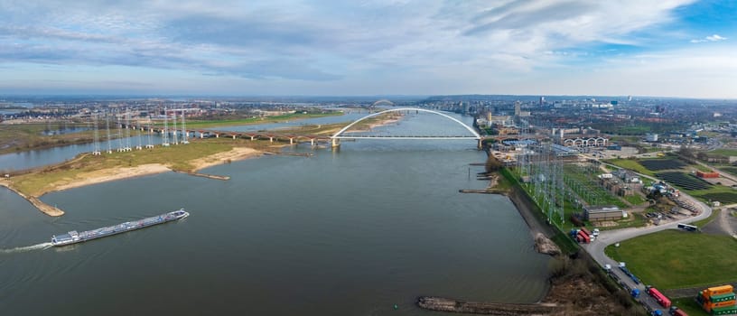 aerial view of a modern bridge called "De Oversteek"" (the Crossing) in Nijmegen, the Netherlands. It crosses the Waal river"