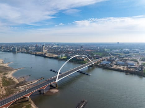 aerial view of a modern bridge called "De Oversteek"" (the Crossing) in Nijmegen, the Netherlands. It crosses the Waal river"