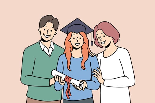 Girl graduate in student hat holds certificate of higher education, standing with parents. Woman graduate of university or college rejoices at receiving diploma of academic degree.