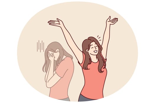 Positive woman raises hands up and rejoices having got rid of bad emotions and depression spoiling mood. Crying doppelganger behind girl for concept of mood swings or split personality