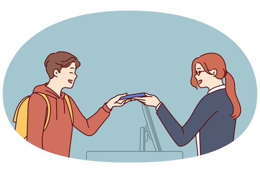 Woman working as secretary or at hotel at reception serves man by holding out magnetic key or invoice for paying for room. Seller girl serves buyer by giving him goods and helps to make choice