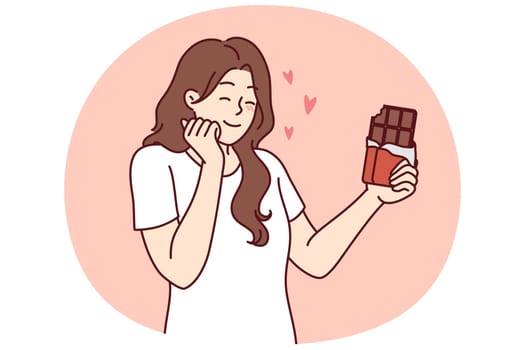 Happy woman enjoying taste of dark chocolate using sweet dessert for snacking and quickly removing hunger. concept of taking milk chocolate with sugar content to fight diabetes and increase insulin