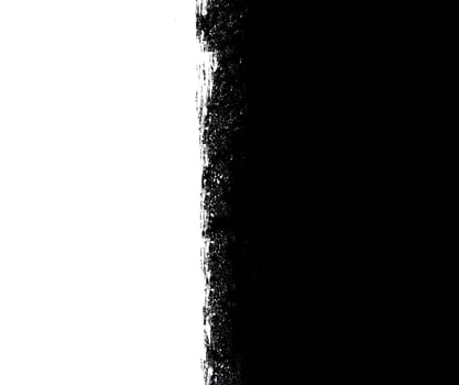 Black and white split surface with uneven edges close-up from above