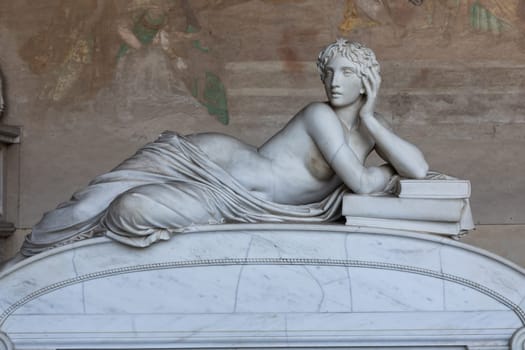 Pisa, Italy - 29 June 2023: sad statue in cemetery. Vintage white marble sculpture, woman sorrow