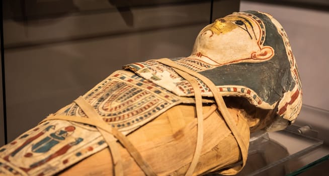 Turin, Italy - March 2023: Egyptian Museum, mummy of a baby with a mask - 2nd Century BC