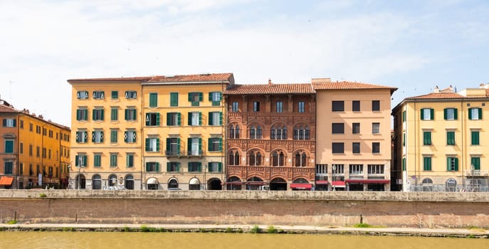 Pisa, Italy - 29 June 2023: colourful buildings on Arno river. Urban skyline, travel destination.