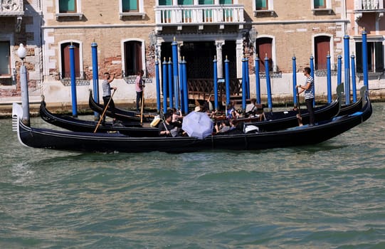 Venice, Italy - September 5, 2022: Tourists during a Gondola cruise on the Grand Canal in Venice. Italy