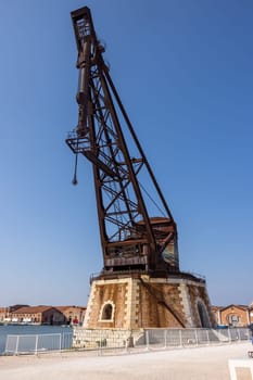 Old port crane at the Venetian Arsenal (Arsenale di Venezia) a complex of former shipyards and armories, Venice, Italy