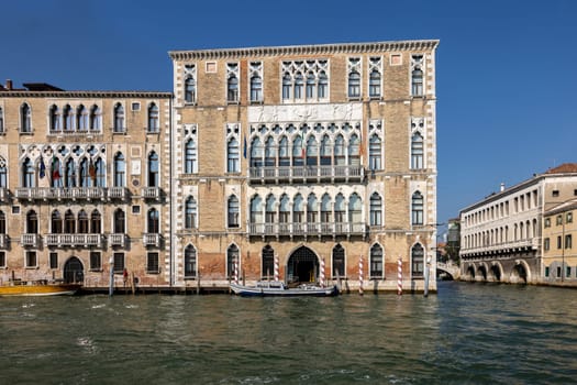Venice, Italy - September 6, 2022: Ca' Foscari palace and the Giustinian palace  at Grand canal in the Dorsoduro district of Venice, Italy.