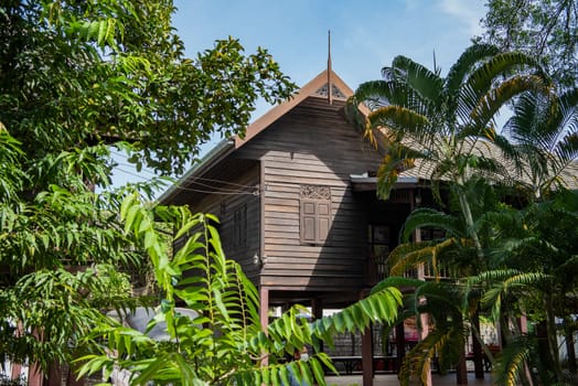a old Wood House at Wat Mani Wanaram in the city centre of Udon Ratchathani and Province Ubon Ratchathani in Thailand.  Thailand, Ubon Ratchathani, November, 23, 2023