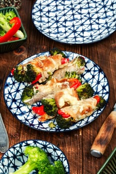 Appetizing meat rolls with broccoli and bell pepper.