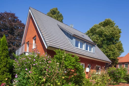 Residential building, single-family brick house with flowers and garden, Leer, East Frisia, Lower Saxony, Germany