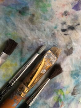 art brushes on spotted canvas, close-up