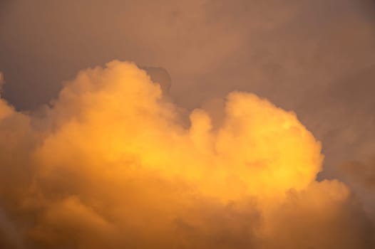 Big yellow cloud in the sky in the evening sun