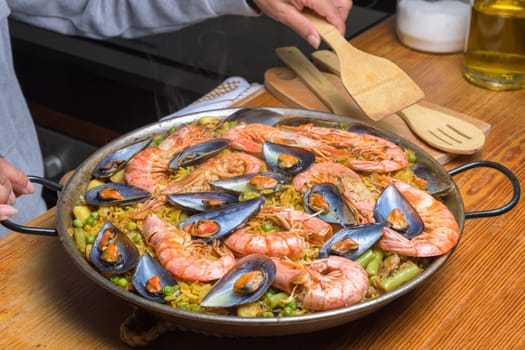 A traditional Spanish paella with shrimp and mussels in a rustic kitchen setup, typical Spanish cuisine, Majorca, Balearic Islands, Spain