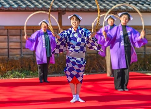 tokyo, edogawa - jan 05 2024: Street performance where Japanese women in traditional outfits dancing and singing while portraying shapes with a Nankin tamasudare music instrument made of bamboo sticks
