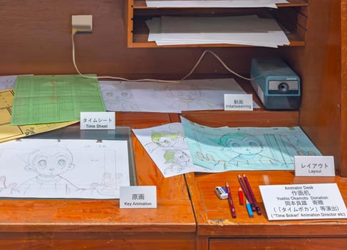 ikebukuro, japan - jan 16 2024: Animator desk exhibited at the free entry museum of Tokyo Anime Station featuring different stages of the creation of an animation illustrated with Astro boy character.