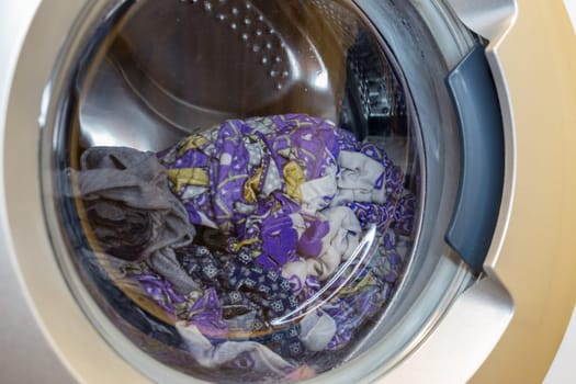 a close view of domestic washing machine at work.
