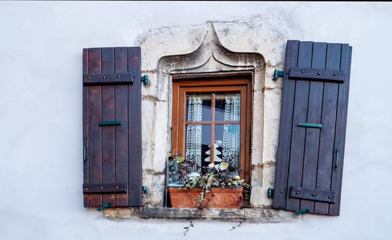 an old wooden window on old wall.