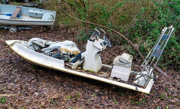 Abandoned motor boat near a forest