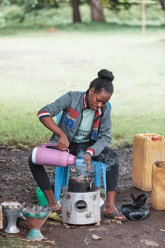 Southern Nations, Ethiopia - April 27, 2019: Woman perform a traditional Ethiopian coffee ceremony, preparing street bunna coffee.