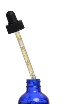 A glass blue bottle with a dropper on a white isolated background, a container for cosmetic products
