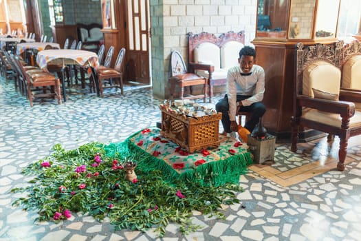 Maqale, Ethiopia - April 27, 2019: Woman perform a traditional Ethiopian coffee ceremony, preparing street bunna coffee.