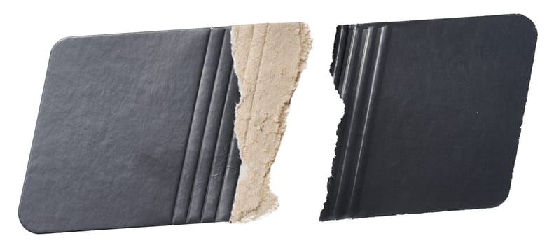 Piece of black cardboard with torn edges on isolated background, close up