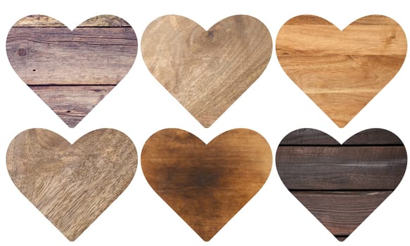 Heart figure carved from different types of wood on an isolated background