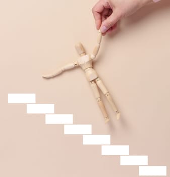Steps and a woman's hand holding figurines, the concept of career growth, help and mentoring