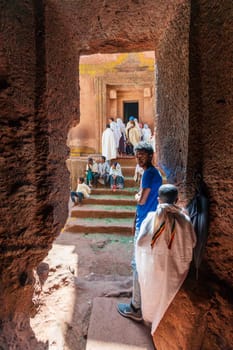 Lalibela, Ethiopia - May 1, 2019: Orthodox Ethiopians unwind at St. George Church after Mass. A serene moment capturing faith and cultural richness.