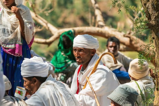 Lalibela, Ethiopia - May 1, 2019: Orthodox Ethiopians unwind at St. George Church after Mass. A serene moment capturing faith and cultural richness.