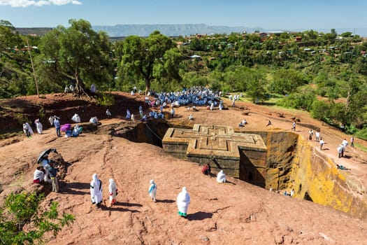 Lalibela, Ethiopia - May 1, 2019: Orthodox Ethiopians unwind at St. George Church after Mass. A serene moment capturing faith and cultural richness.