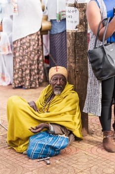 BAHIR DAR, ETHIOPIA, APRIL 21th. 2019, Old orthodox Christian monk resting on the street of Bahir Dar during Easter holiday. April 21th. 2019, Bahir Dar, Etiopia