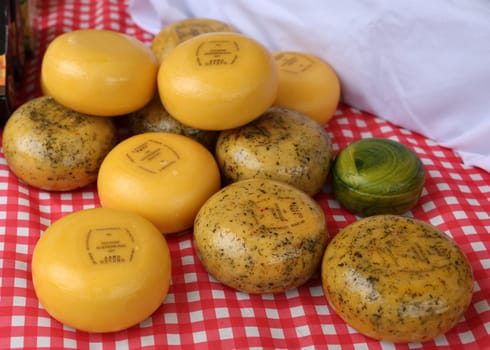 Gouda, the Netherlands - April 20, 2023: Traditional Dutch Gouda cheese at a street stall on Thursday traditional cheese market  day in Gouda, the Netherlands