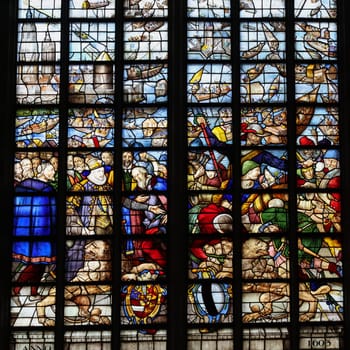 Gouda, the Nehterlands - April 20, 2023: The Stained glass window Siege of Leiden ends  by Isaac van Swanenburg in the Sint Janskerk in Gouda, the Nehterlands
