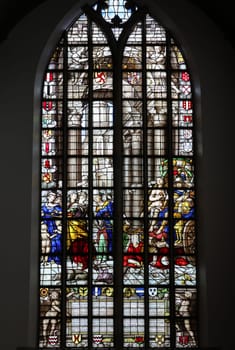 Gouda, the Nehterlands - April 20, 2023: The Stained glass window the Freedom of Conscience by Joachim Wtewael in the Sint Janskerk in Gouda, the Nehterlands