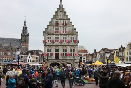 Gouda, the Nehterlands - April 20, 2023: The famous cheese market at the town hall in Gouda, the Nehterlands