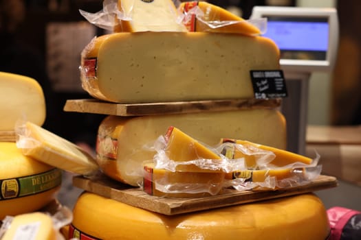 Gouda, the Nehterlands - April 20, 2023: Display of traditional Dutch cheese at local cheese shop in Gouda, the Netherlands