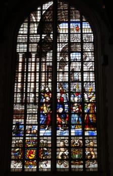 Gouda, the Nehterlands - April 20, 2023: The Stained glass window Jesus and the adultress by Claes Wytmans in the Sint Janskerk in Gouda, the Nehterlands