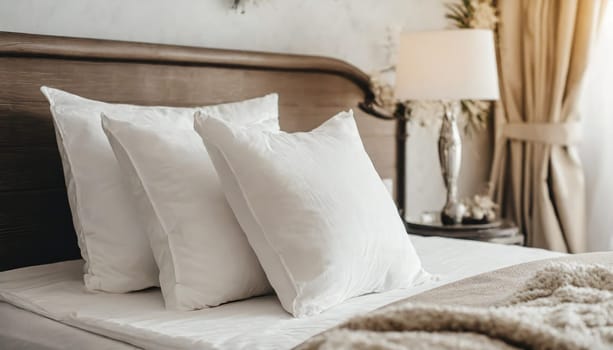 Clean Bedding sheets and pillow on natural wall room background. White bedding and pillow in hotel room. White pillows on empty bed.