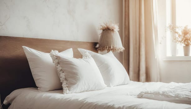 Clean Bedding sheets and pillow on natural wall room background. White bedding and pillow in hotel room. White pillows on empty bed.